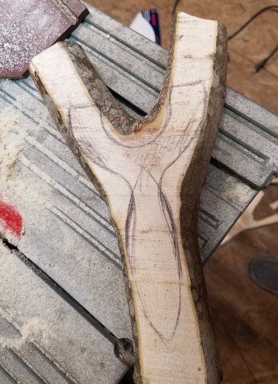 Sparrow outline traced on a rough maple fork